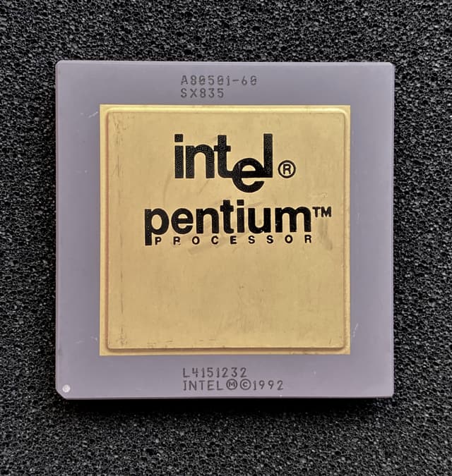 An Intel Pentium processor: a grey ceramic package with a gold lid, marked A80501-60, SX835, L4151232 and INTEL 1992, on black foam.
